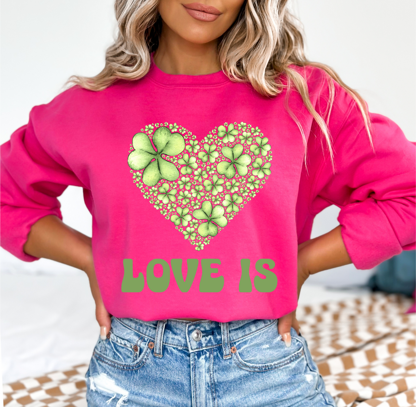 Embrace Love's Warmth: Introducing 'Love is' Gildan 18000 Sweatshirts - Whimsical Designs, Shamrock & Heart, Cozy Comfort, Thoughtful Sizing