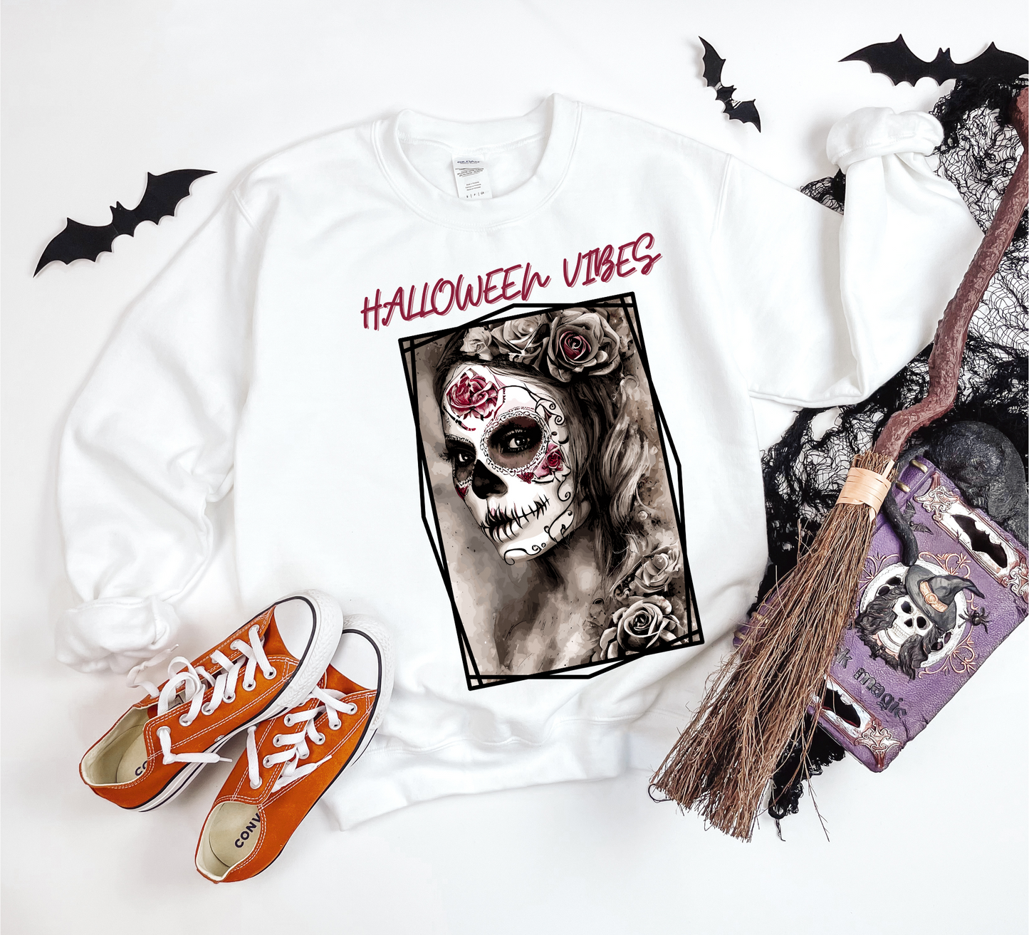 Explore our bewitching collection of Halloween sweatshirts, showcasing the mysterious allure of a Sugar-masked, Goth-style witch on the front.