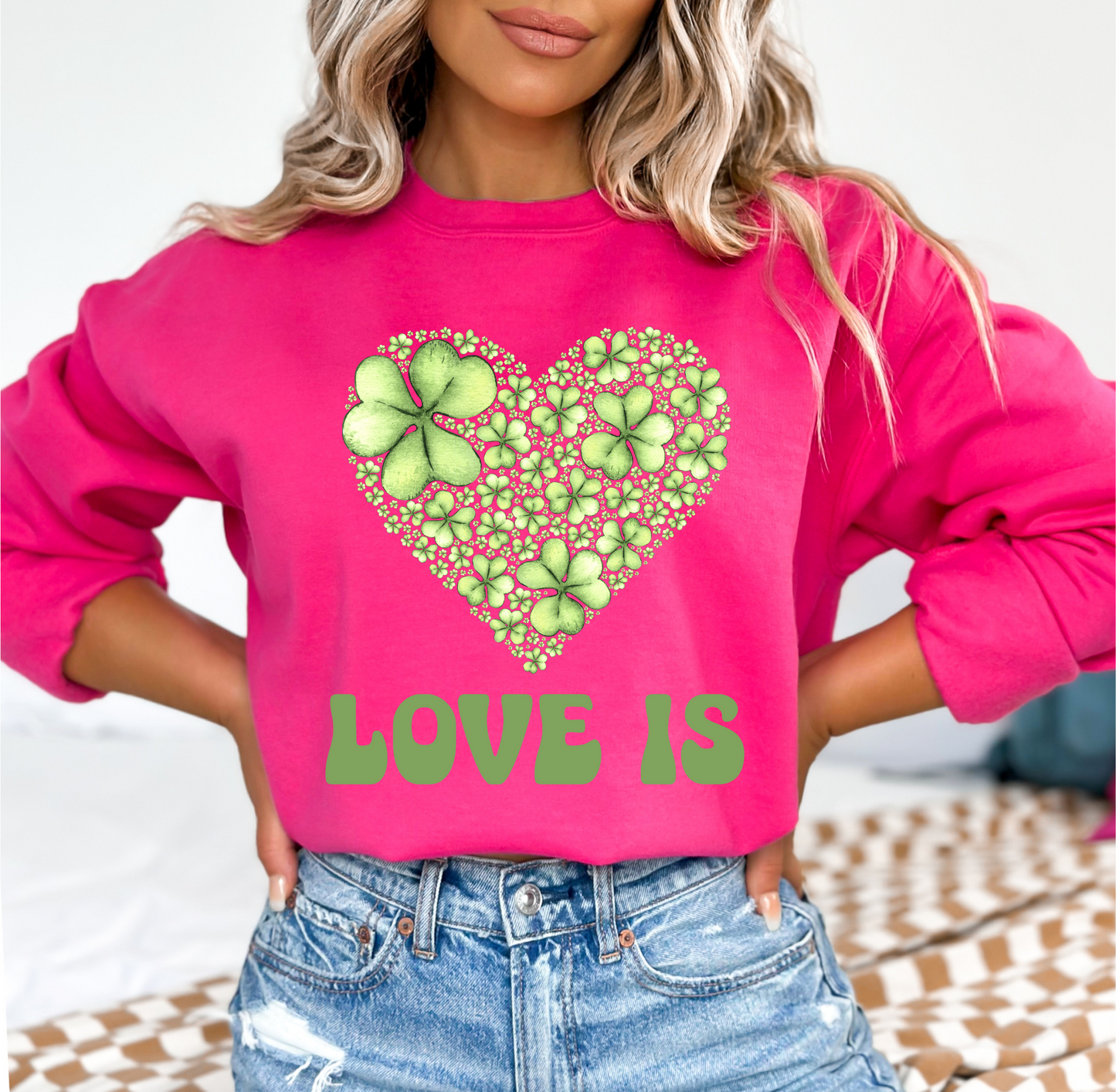 Embrace Love's Warmth:  Introducing 'Love is' Gildan 18000 Sweatshirts - Whimsical Designs, Shamrock & Heart, Cozy Comfort, Thoughtful Sizing