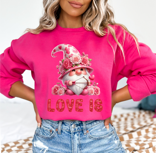 Embrace Love's Warmth: Introducing our Cupid Gnome, 'Love is' Gildan 18000 Sweatshirts – Whimsical Designs, Cozy Comfort, Thoughtful Sizing.