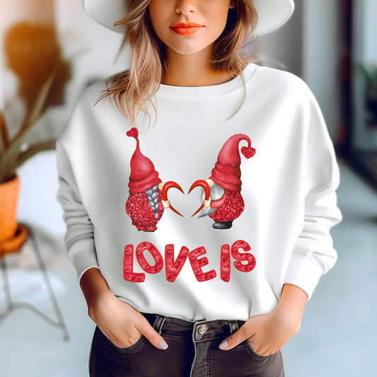 Embrace Love's Warmth:  Introducing our Gnome of Hearts, 'Love is' Gildan 18000 Sweatshirts – Whimsical Designs, Cozy Comfort.