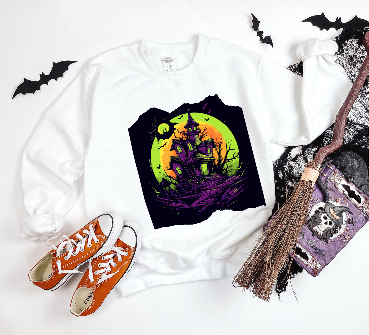 Explore our bewitching collection of Halloween sweatshirts, showcasing the mysterious allure of a haunted house on the front.